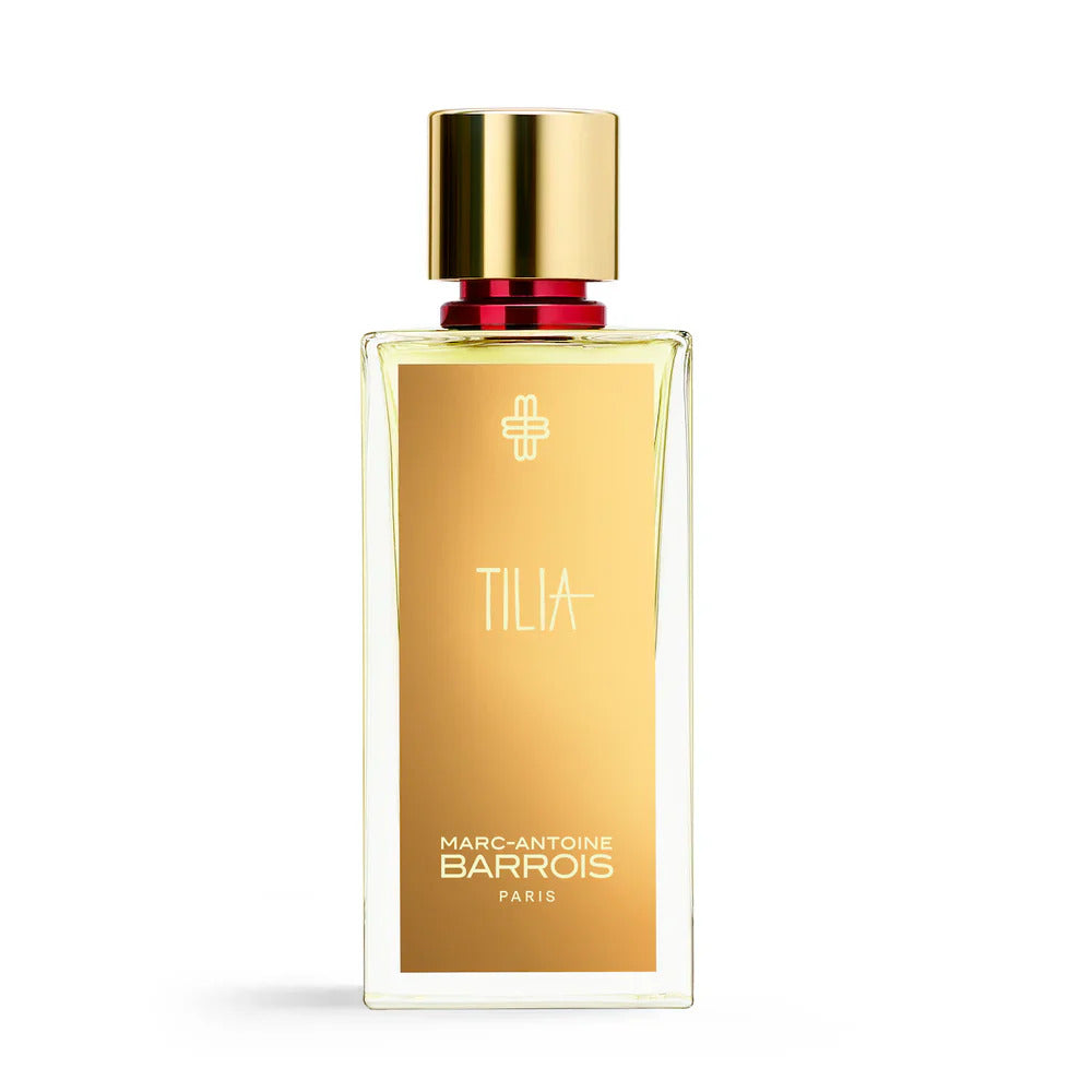 Gold perfume bottle with red cap on a white background