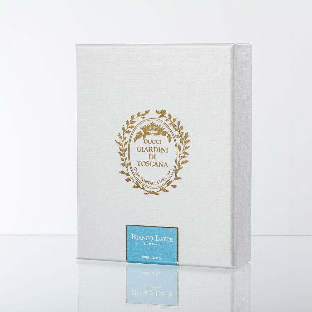 White packaging box with gold emblem and blue label on a white background