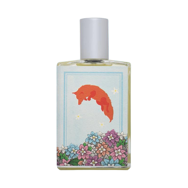 Perfume bottle with fox and floral design on a light blue background