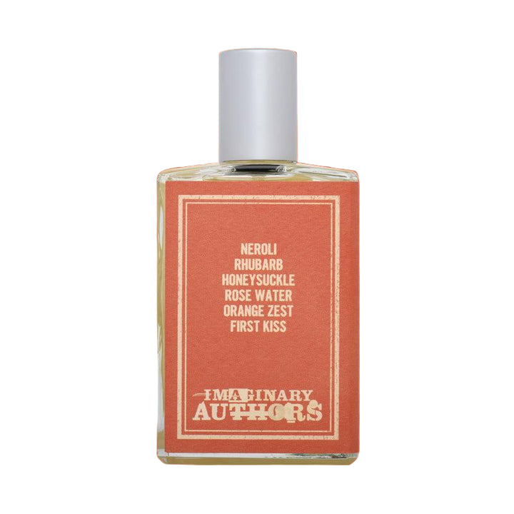 Perfume bottle with red label on an orange background