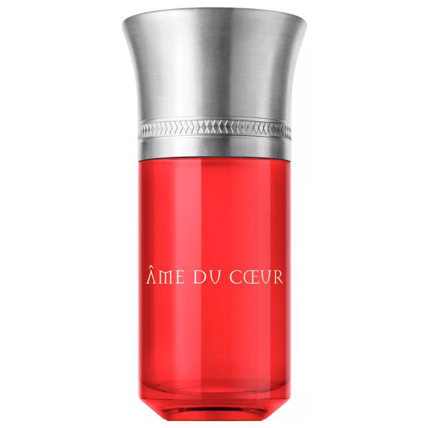 Red perfume bottle with silver cap on a white background
