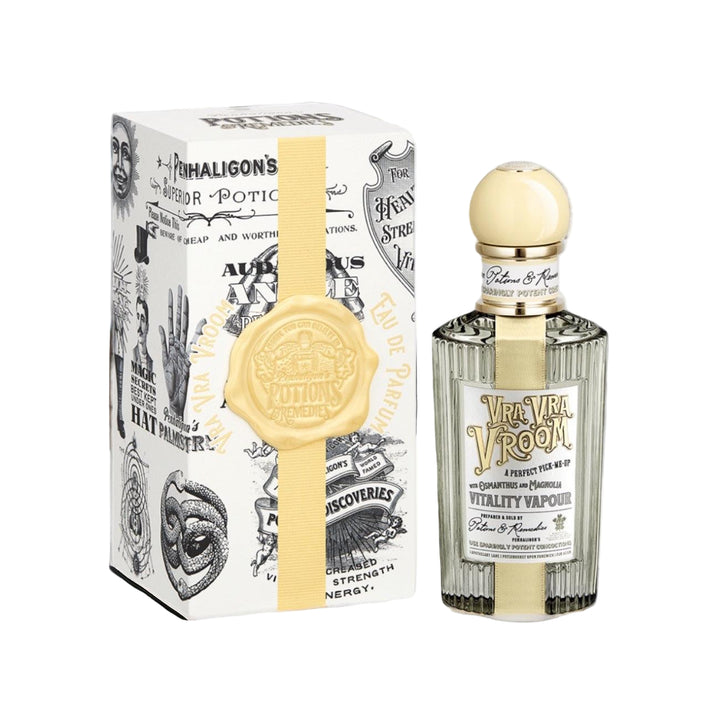 Perfume bottle and packaging with a decorative design on a white surface