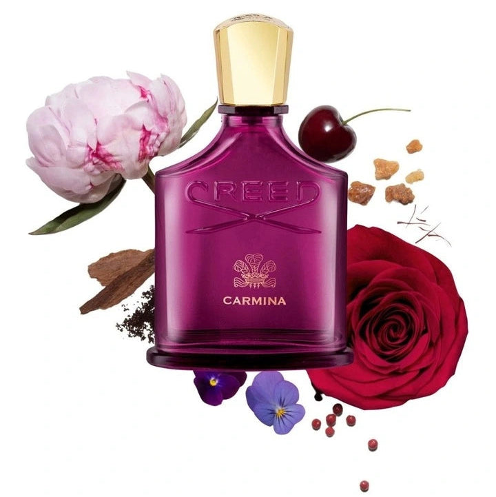Perfume bottle labeled 'Carmina' with flowers and spices on a white background