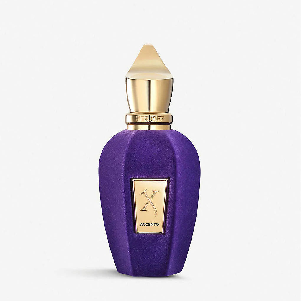 Purple perfume bottle with gold cap on a white background